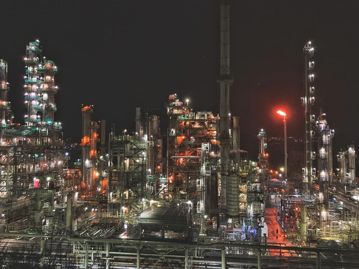 photo of an oil refinery at night
